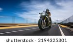 Small photo of motorbike on the road fast driving. having fun driving the empty road on a motorcycle tour journey. copyspace for your individual text. motion blur shot