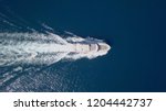 Large speedboat roaring across the Mediterranean Sea - Top down aerial image.