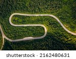 Bird's eye view from a drone flying over a winding road. Location place of Carpathians mountain, Ukraine, Europe. World landmarks. Photo wallpaper. Drone photography. Discover the beauty of earth.