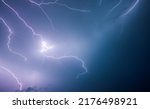 Small photo of A strong storm with bright lightning illuminating ominous clouds. Exotic image of cloud texture. Adverse weather conditions