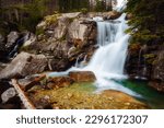 Stunning scenery of the rapids of a Dlhy waterfall flowing through rocky mountains in a green forest. Location place National Park High Tatra, Slovakia, Europe. Photo wallpaper. Beauty of earth.