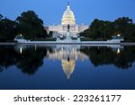 United States Capitol, Government in Washington, D.C., United States of America. Illuminated at night with reflection showing in reflecting pool. 