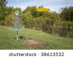 A frisbee golf target with a disc inbound