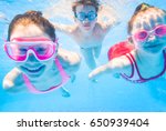 Little Kids Swimming  In Pool