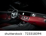 Red luxury car Interior - steering wheel, shift lever and dashboard. Clipping path for windows included