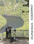 Small photo of QUEUILLE, FRANCE, May 6, 2016 : Young couple does selfie in Meandres de Queuille. Left tributary of the river Allier, the Sioule river has cut a deep gorge in the landscape.