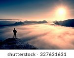 Man Stands On The Peak Of...