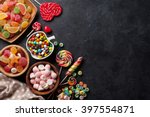 Colorful candies, jelly and marmalade on stone background. Top view with copy space