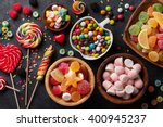 Colorful candies, jelly and marmalade on stone background. Top view