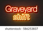 Small photo of Graveyard shift neon sign on brick wall background