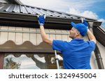 Man Installing House Roof Rain...