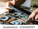 technician change and insert new laptop battery. computer repair service