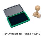 Small photo of Rubber stamp with green stamp pad on a white background