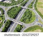 Aerial high drone in 4K flight over road traffic. Highway and overpass with cars and trucks, interchange, two-level road junction in the big city. Top view. 