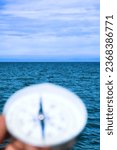 Small photo of The right compass is always needed for travelers, adequate course. Hiking on the shore of Lake Baikal in Siberia