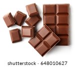 Milk chocolate pieces isolated on white background from top view