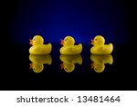 A Row Of 3 Rubber Ducks On A...