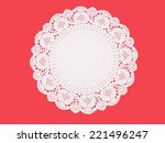 Paper doily on textured red. Celebration background.
