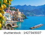 Small town Atrani on Amalfi Coast in province of Salerno, Campania region, Italy. Amalfi coast on Gulf of Salerno is popular travel and holyday destination in Italy. Ripe yellow lemons in foreground.