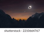 Small photo of Total solar eclipse over high mountains, amazing dark mysterious scientific image. During eclipse disk of Sun is completely covered by Moon.