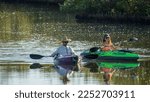 Small photo of BRADENTON, FLORIDA, USA - JANUARY 8, 2023: Two adult kayakers enjoy a leisurely outing together along a lagoon lined with mangrove in a nature preserve along the Gulf Coast of southwest Florida.