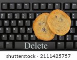 Small photo of Delete internet web browser metaphor with a keyboard and chocolate chip cookies