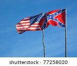 Flags of American civil war. Union flag and Confederate flag under blue sky.