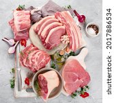Small photo of Assortment of raw pork meat on light grey background. Organic gourmet food concept. Top view, flat lay
