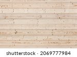 Small photo of Natural uncolored wooden wall made of pine tree boards, front view. Seamless background photo texture