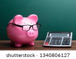 Calculator And Pink Piggybank...