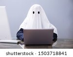 Small photo of Ghostwriter Writing Article On Laptop In Office