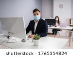 Small photo of Business Employees In Office Wearing Medical Masks And Following Social Distancing Protocols
