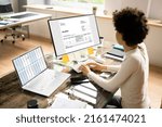 Small photo of Accountant Using E Invoice Software At Computer In Office