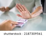 Small photo of Cropped Hand Of Businessperson Refusing To Take Bribe From Partner At Workplace
