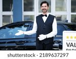 Small photo of Valet Parking Hotel Service. Man Driver Standing