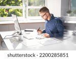 Small photo of Accountant Using E Invoice Software At Computer In Office