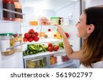 Close-up Of Young Woman Searching For Food In The Fridge