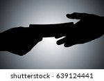 Silhouette Of Hands Giving...