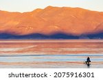 Small photo of Fisherman on a ladder in Pyramid Lake, Nevada targeting Lahotan cutthroat trout
