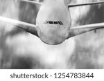 Small photo of an airplane flying mid air speed blur in black and white