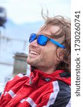 Small photo of A happy yachtsman on the fishing boat in open sea in Norway