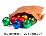 Colorful chocolate balls in a jute sack