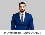 Small photo of Self confident bearded male looking at camera with serious expression, unsmiling determined business man, wearing official style suit. Indoor studio shot isolated on gray background.