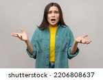 Small photo of How could you? Disgruntled woman with dark hair indignantly asking reason of failure, claims in conflict, why hand gesture, wearing casual style jacket. Indoor studio shot isolated on gray background.