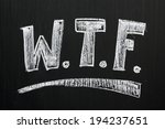 Small photo of The abbreviation for a well known expletive expression on a blackboard, often used when a person wonders what is going on in a situation