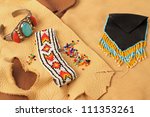 Small photo of Still life with turquoise and silver wrist band, beaded bracelet and Indian Wampum Bag on assorted scraps of leather and buckskin.