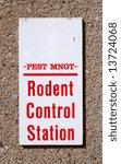 Small photo of Sign reading Pest Mgmt Rodent Control Station on a wall