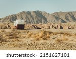 Small photo of Motor Coach RV Southern California Desert Boondocking. Class A Diesel Pusher Motorhome Dry Camping in a Wild. Outdoors Pursuit Theme.