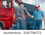 Small photo of Meeting of Two Lorry Drivers In a Parking Lot to Swap Shifts. Man Passing the Keys of Red Semi Truck to His Colleague to Continue the Delivery. Safety Rules For Heavy Duty Transportation.