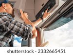 Small photo of Professional Truck Driver Using CB Radio To Communicate with Others in a Convoy